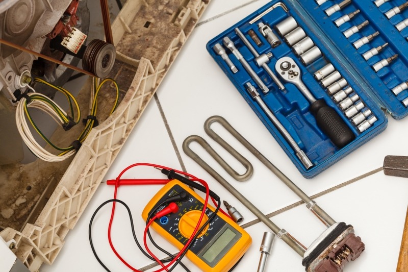 Engineer repairing a washing machine in Dagenham